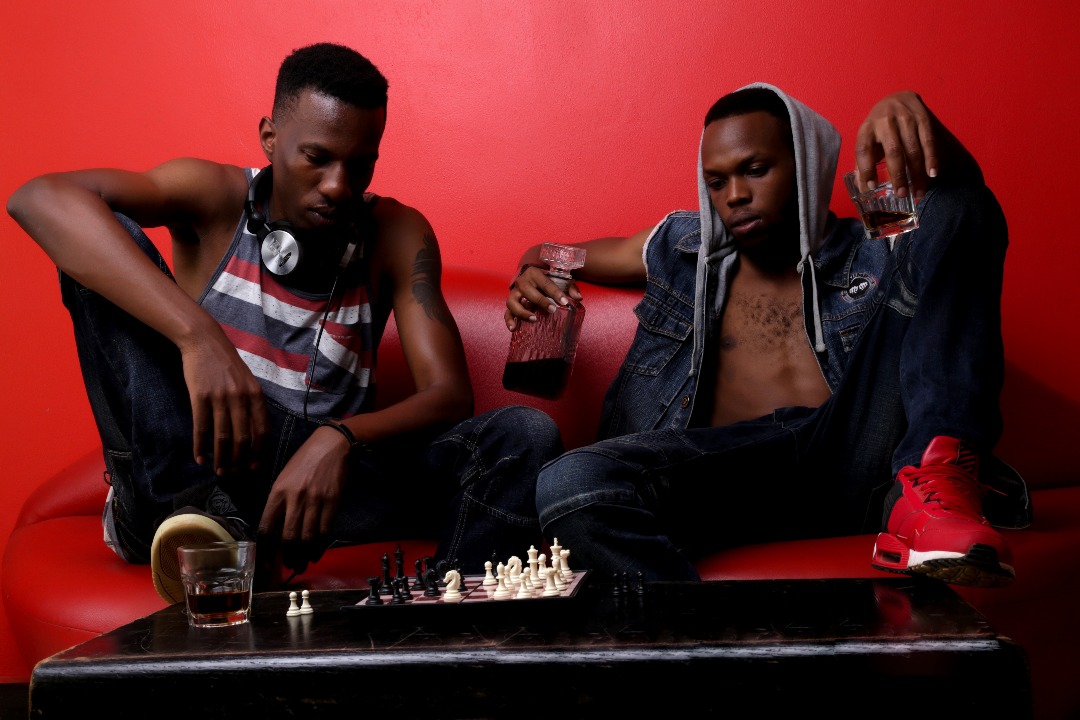 Delboy and another artist beside a chessboard during a photo session