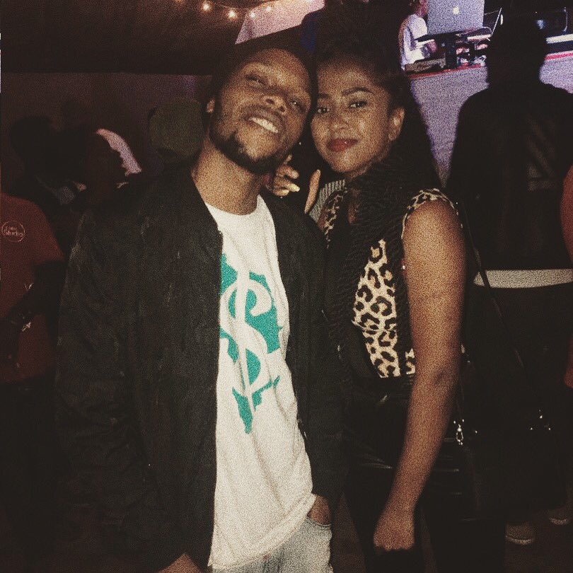 Del smiling alongside another person at an event